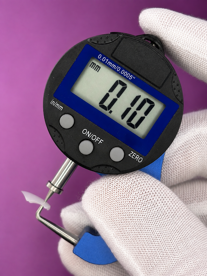 Digital caliper measuring a prepless zirconia veneer at 0.10mm, 100 microns, milled by Dr. Cvetan Mechev at La Mesa Dental Center